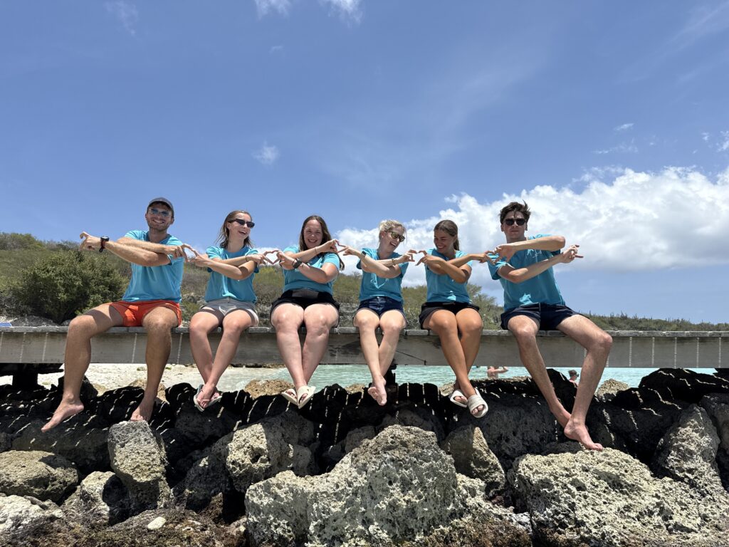 Interns of BRANCH Coral Foundation on the beach after a coral restoration dive